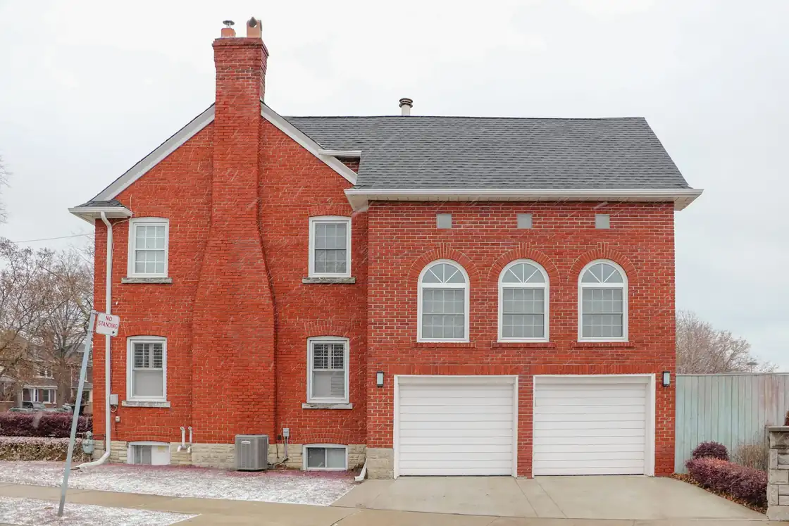 Two-storey red brick detached house with a double garage