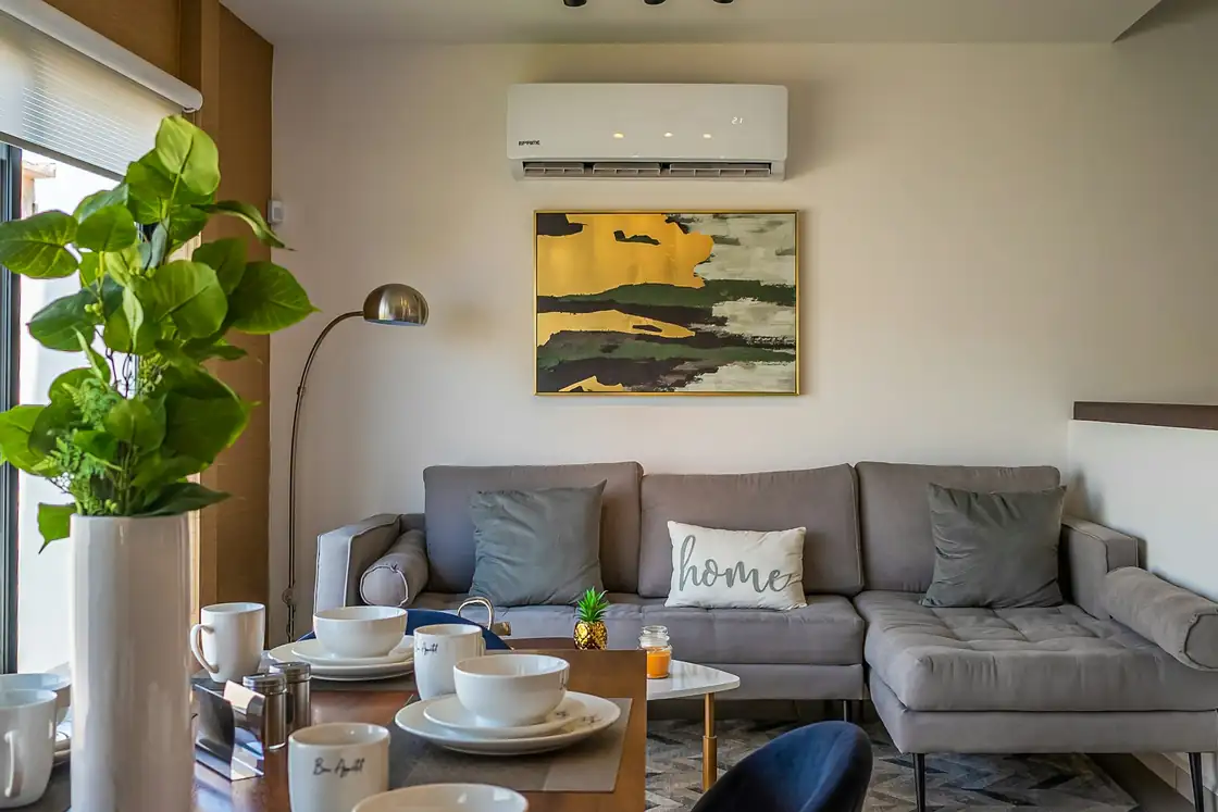 Living room with a ductless mini-split head mounted high on the wall