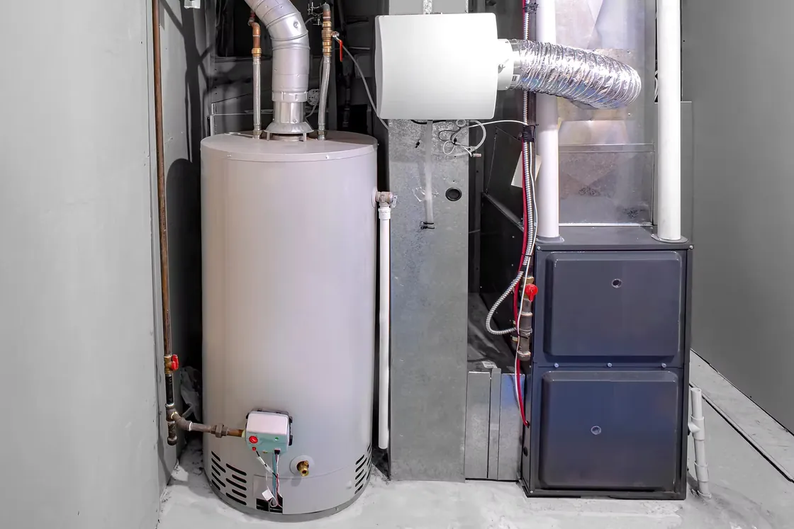 Gas furnace and tank water heater side by side in a basement utility room
